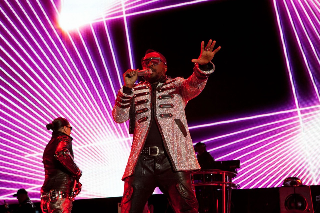 Impact backed a headlining performer with an LED wall of pink laser-line graphics and stage lighting.