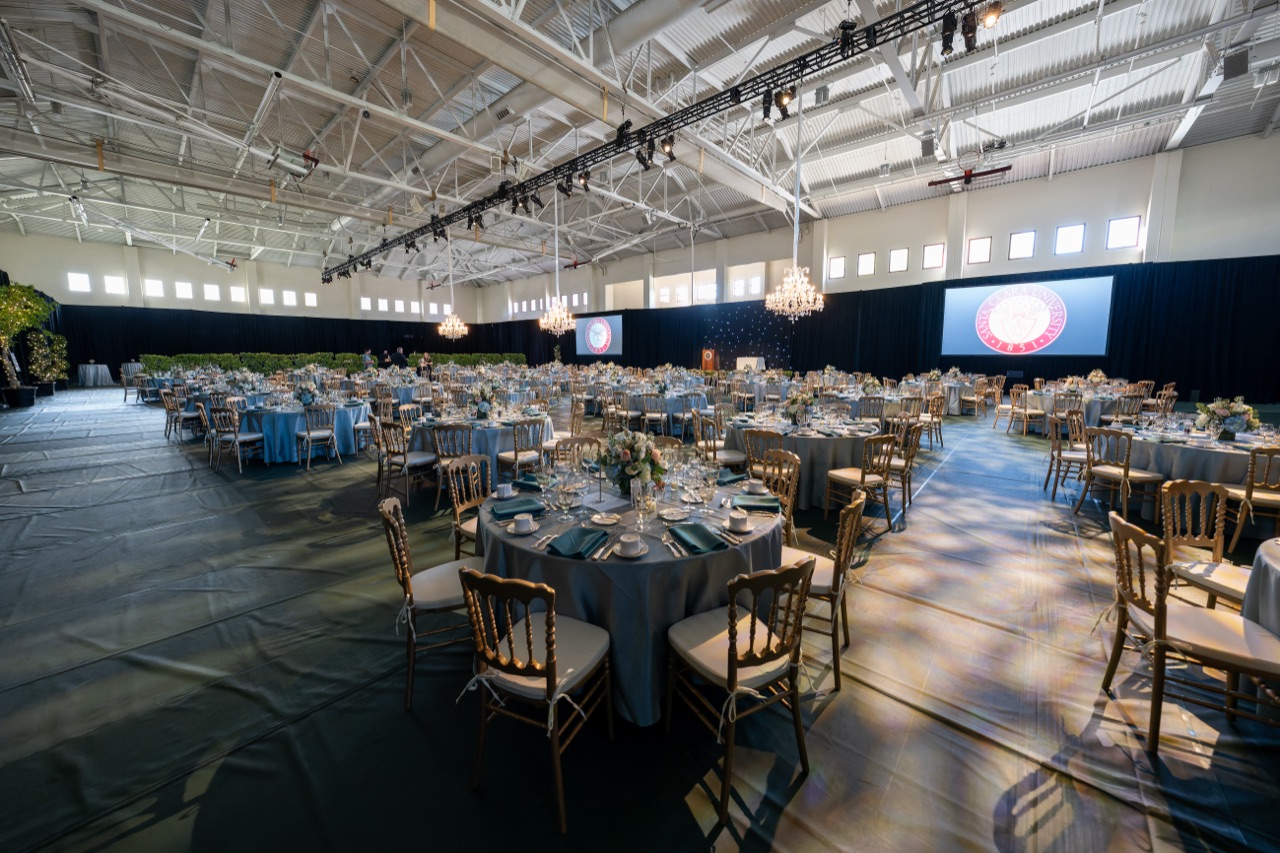 Impact lit a hangar gala with hanging chandeliers, a branded LED screen, and a projected gobo dance floor for the USC President's Dinner.