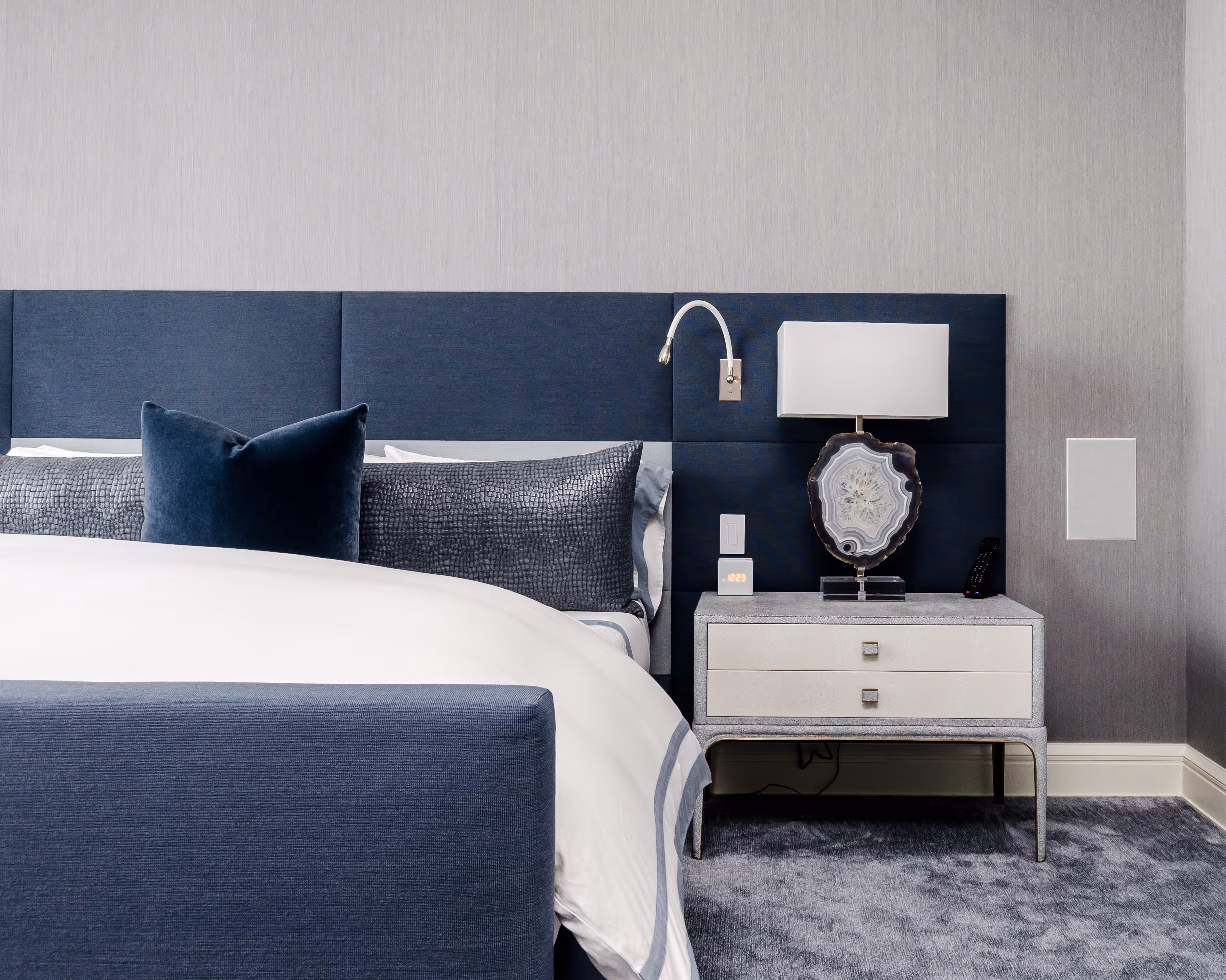 image of a hotel bed and side table 