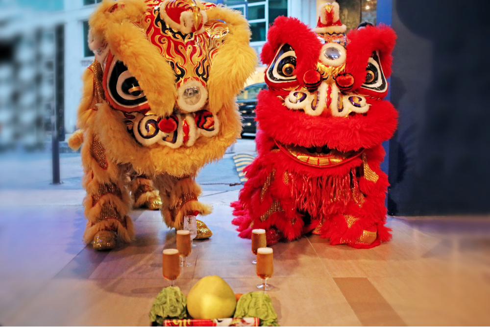 Lion dance troupe performing at a booking in an office in Singapore