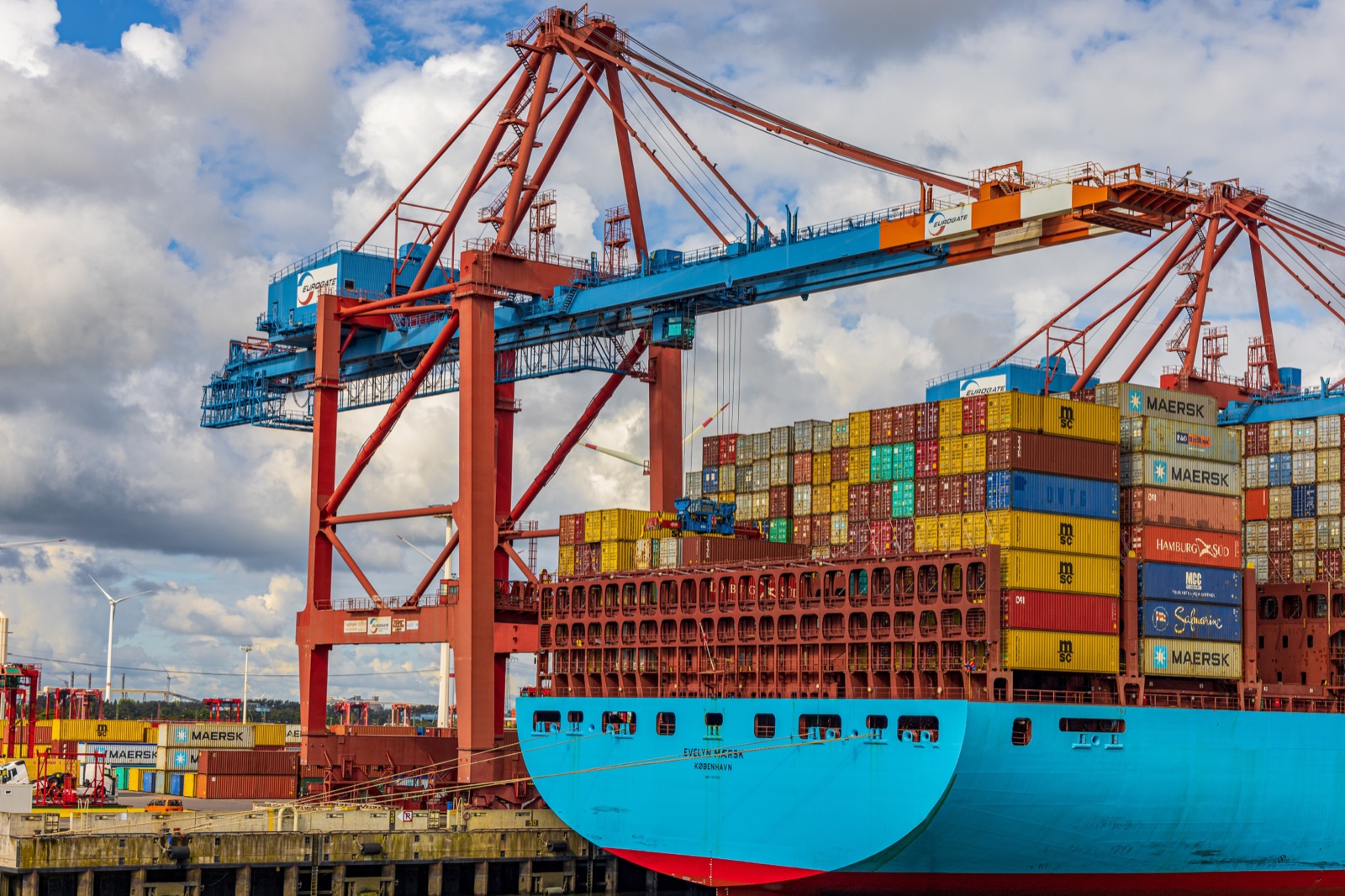 Container ship being loaded by port cranes