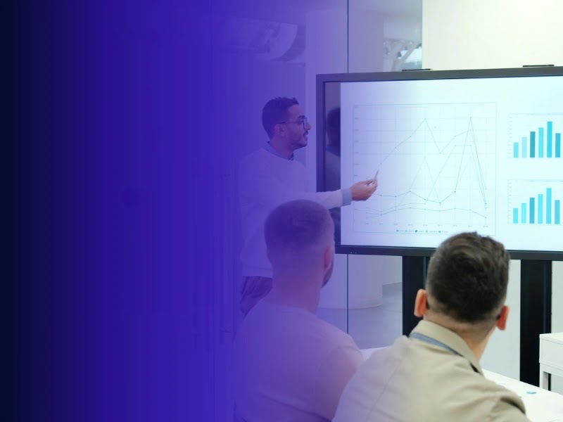 Colleagues review charts during a product-development performance meeting.