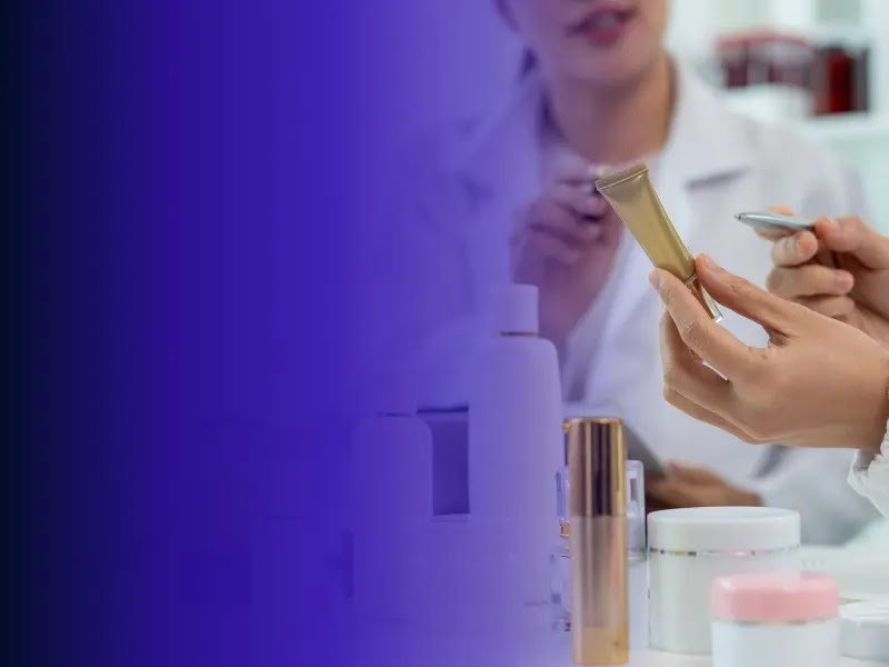 Personal-care researchers review a cosmetic product tube and formulation samples.