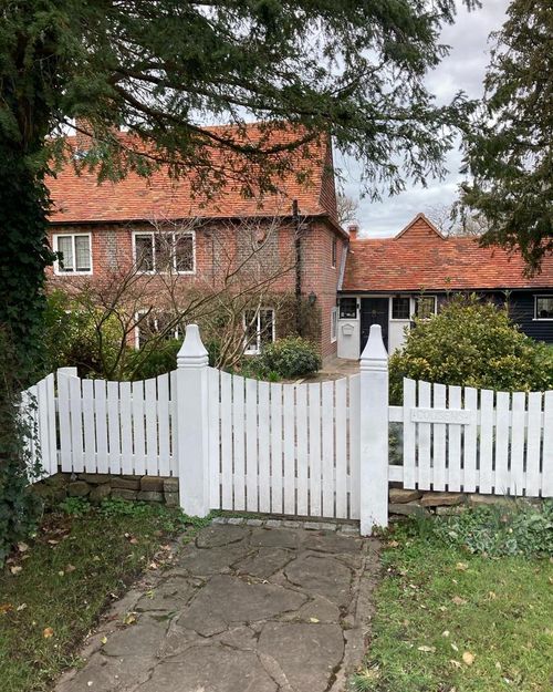 a garden gate leading to a house