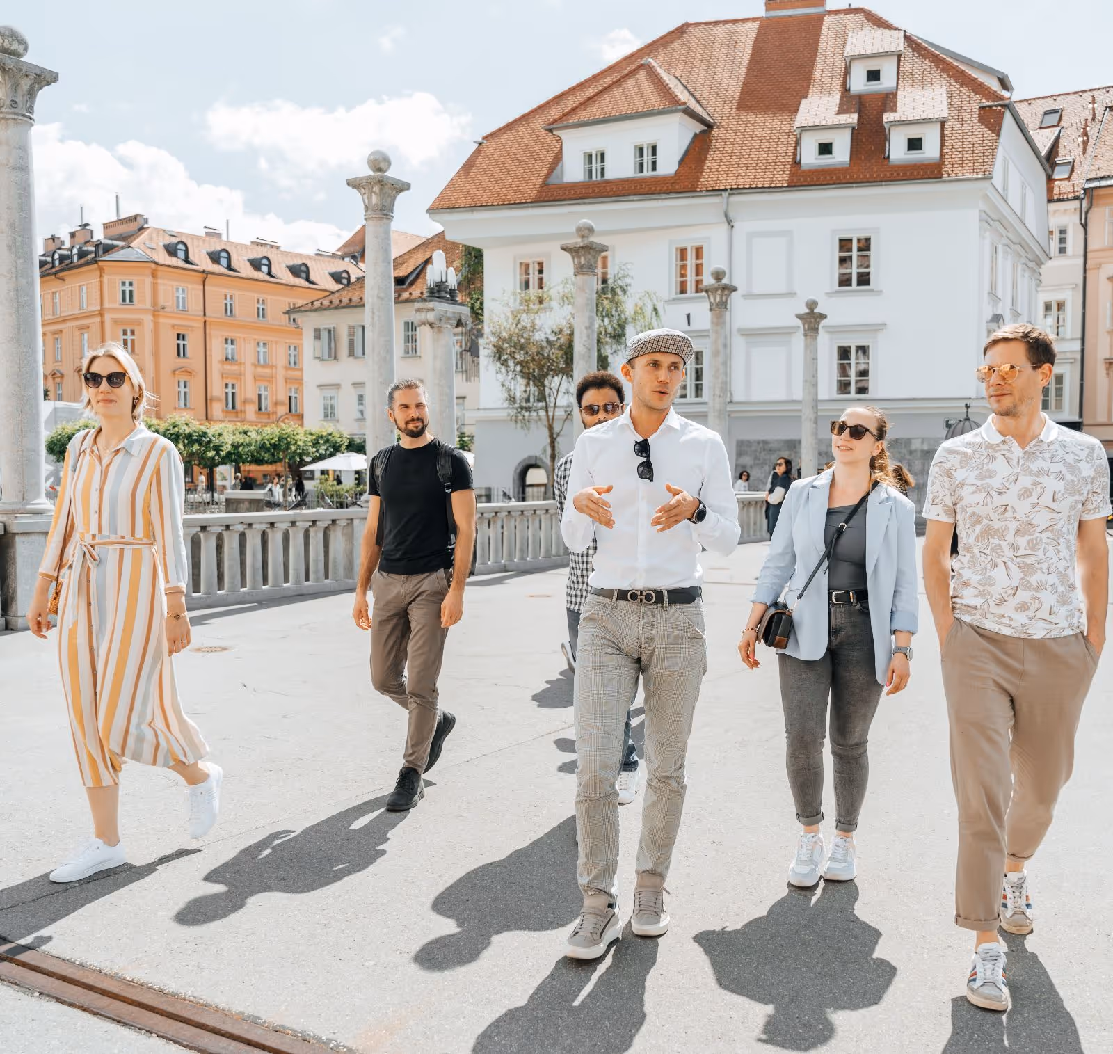 Tour Group walking and talking while crossing Ljubljana's Cobbler Bridge