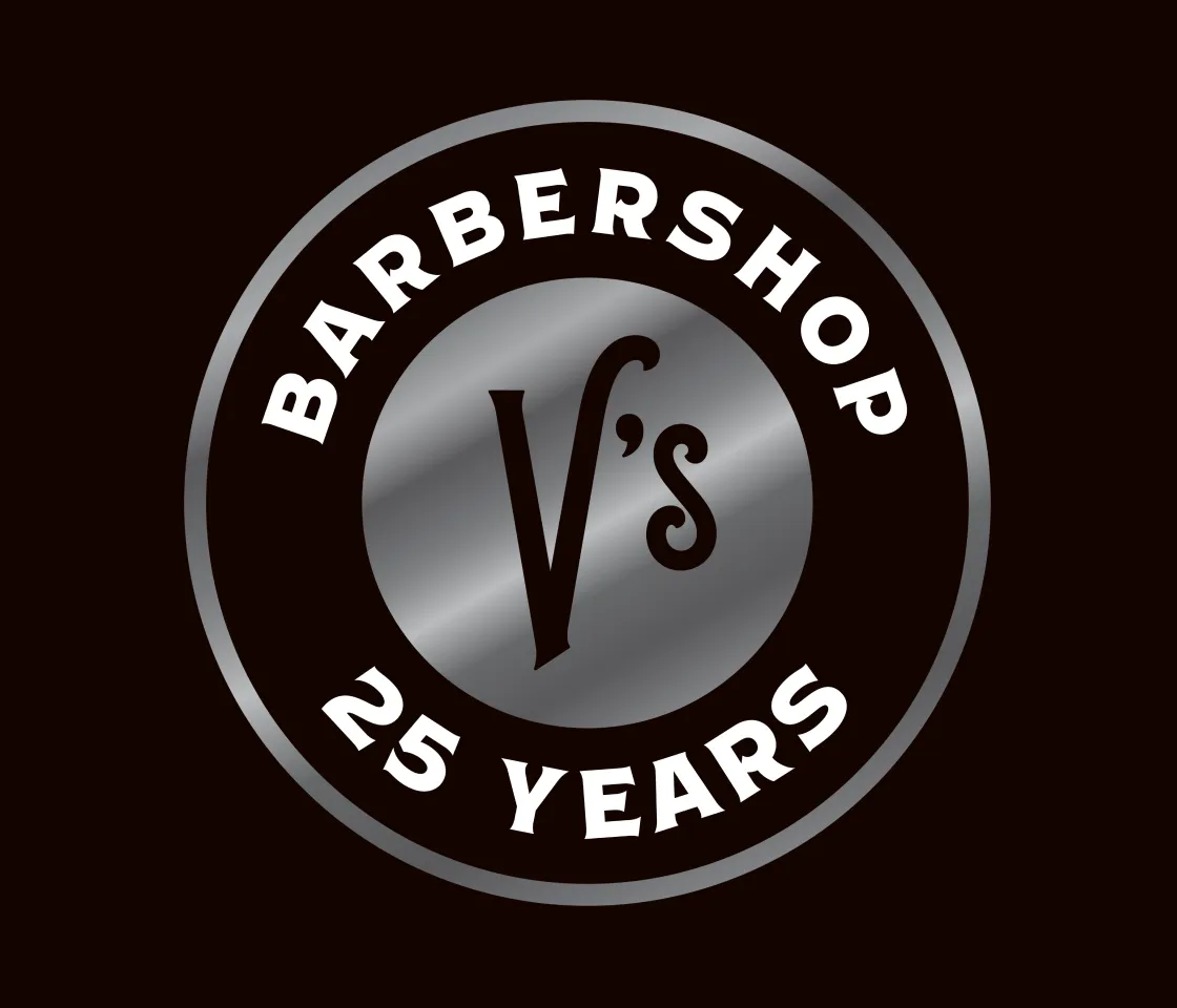 V's Barbershop 25 Years anniversary circular badge logo in silver metallic finish on dark brown background, brand identity by Unbound Collective