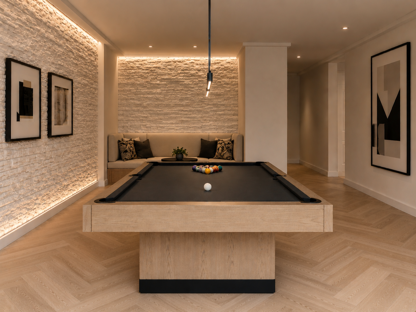 Modern game room with a wood pool table, black felt, lounge seating, accent lighting, and abstract art.