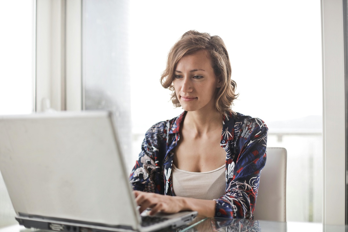 Woman sitting and typing on her laptop.