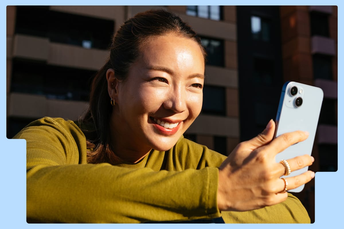 woman smiling at her phone