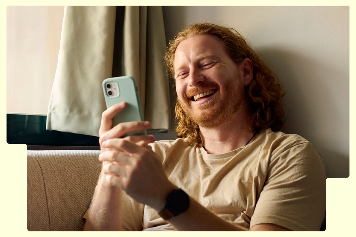 Man laughing at his phone