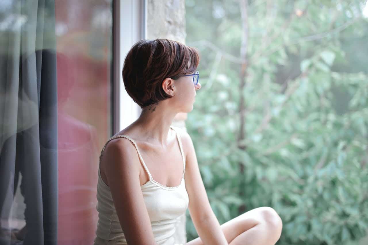 calm grounded woman staring outside