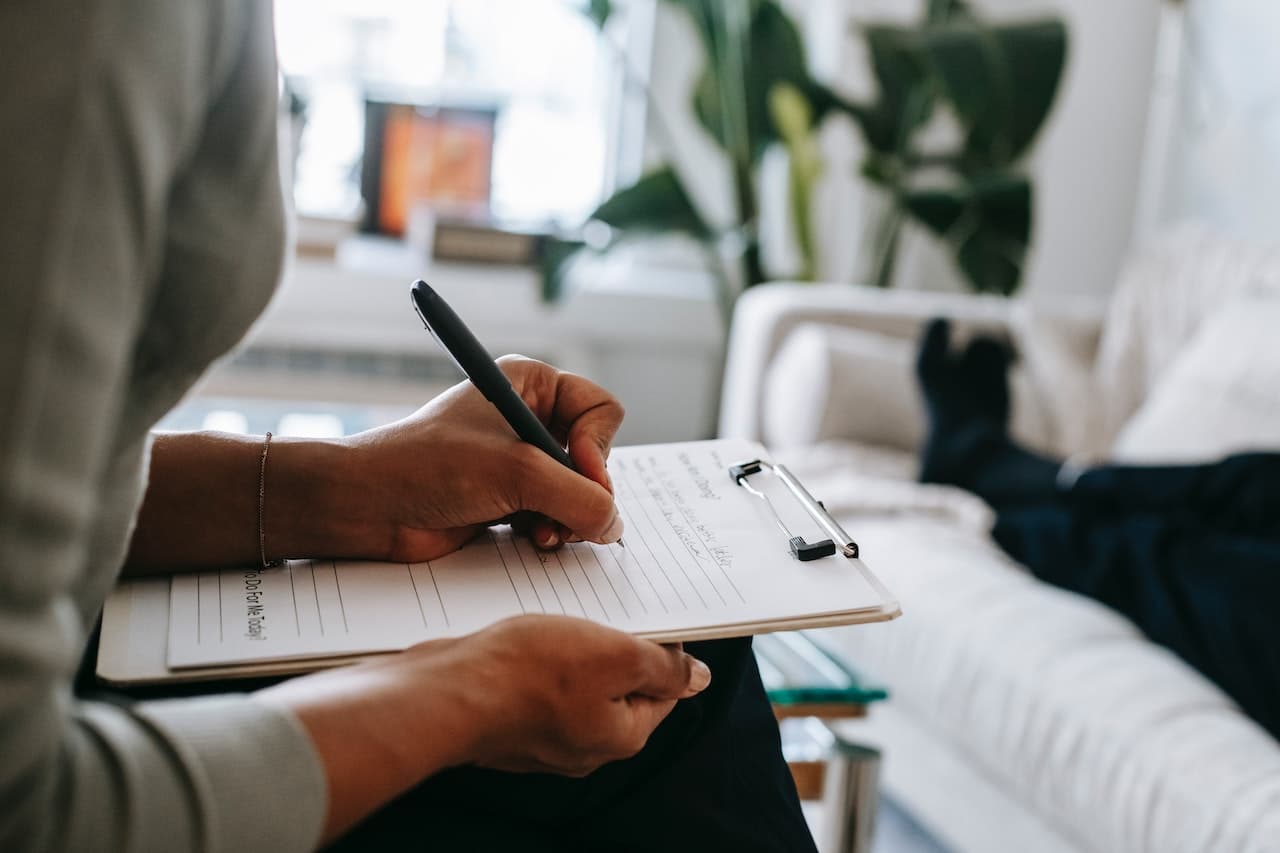 person-writing-on-clipboard