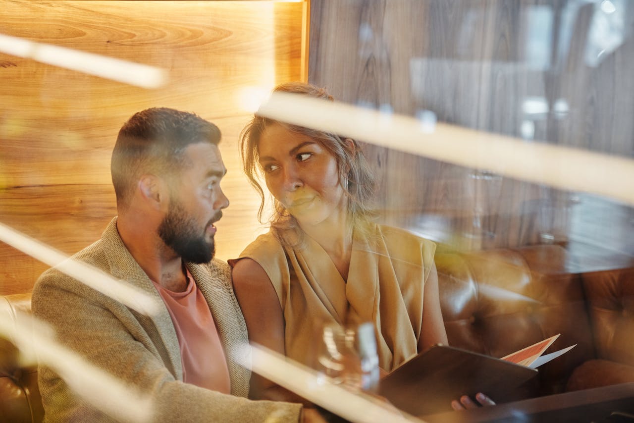 couple sitting next to each other on date