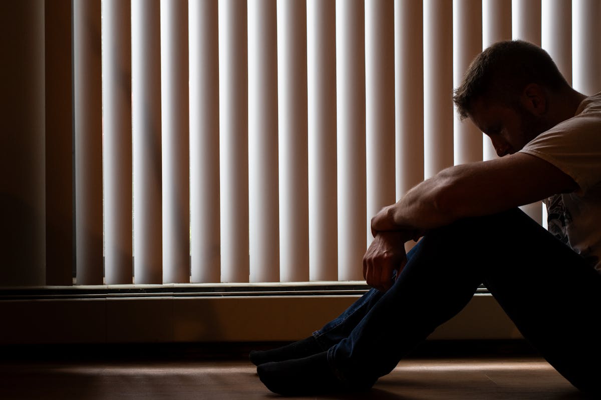 A man sitting in front of the window