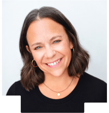 Smiling woman with shoulder-length brown hair wearing gold hoop earrings and a black top.