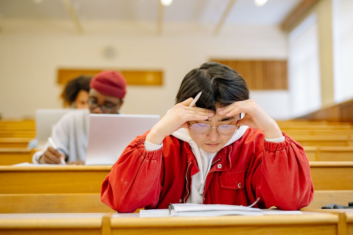 A student focused on their studies inside a university lecture