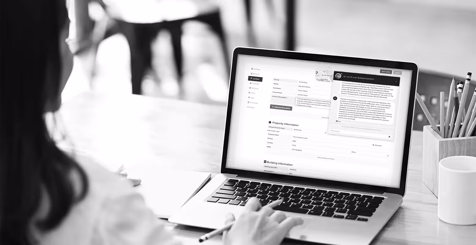 Over the shoulder view of woman on a laptop using Buildout's AI tool AL