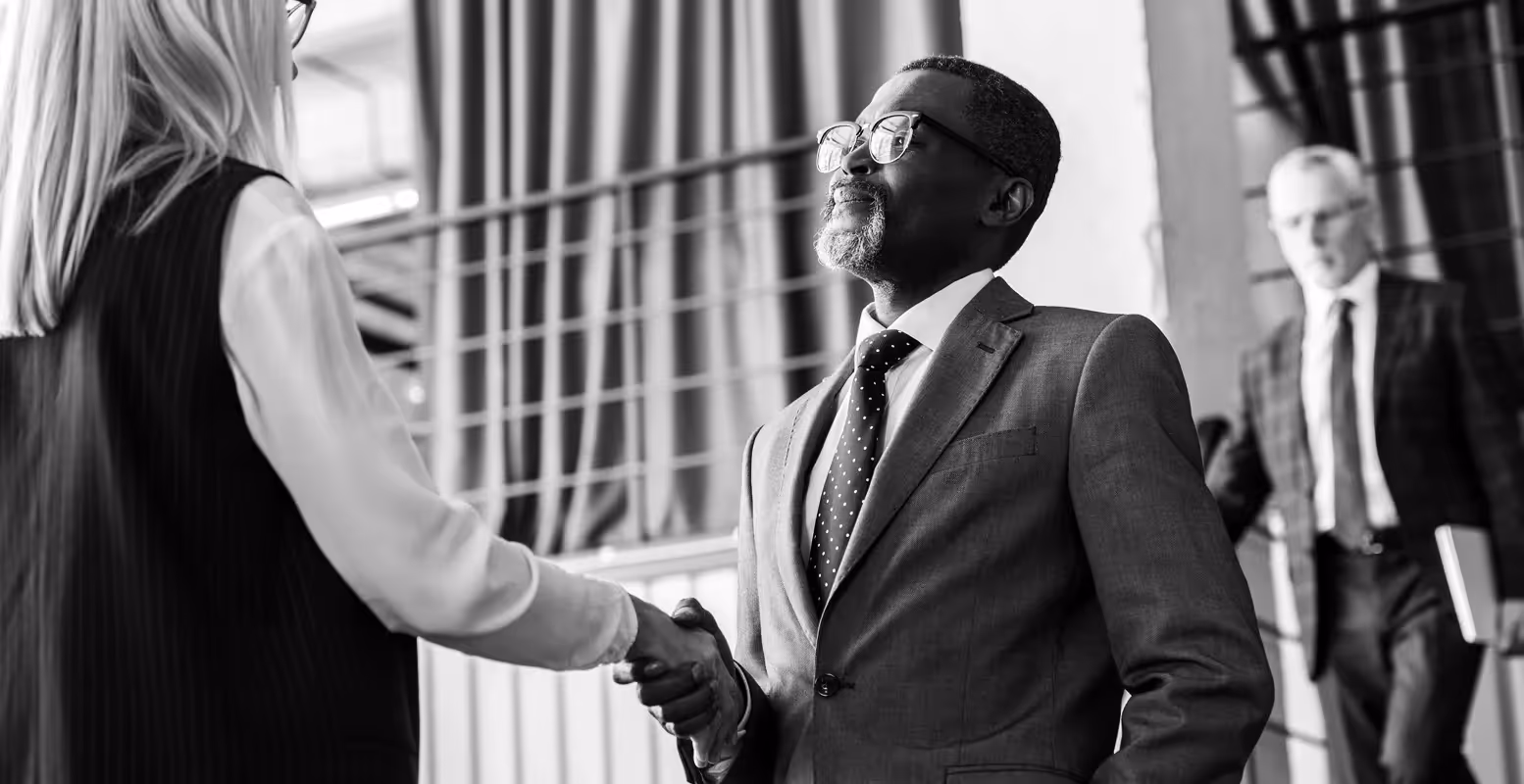 Two business people shaking hands in an office