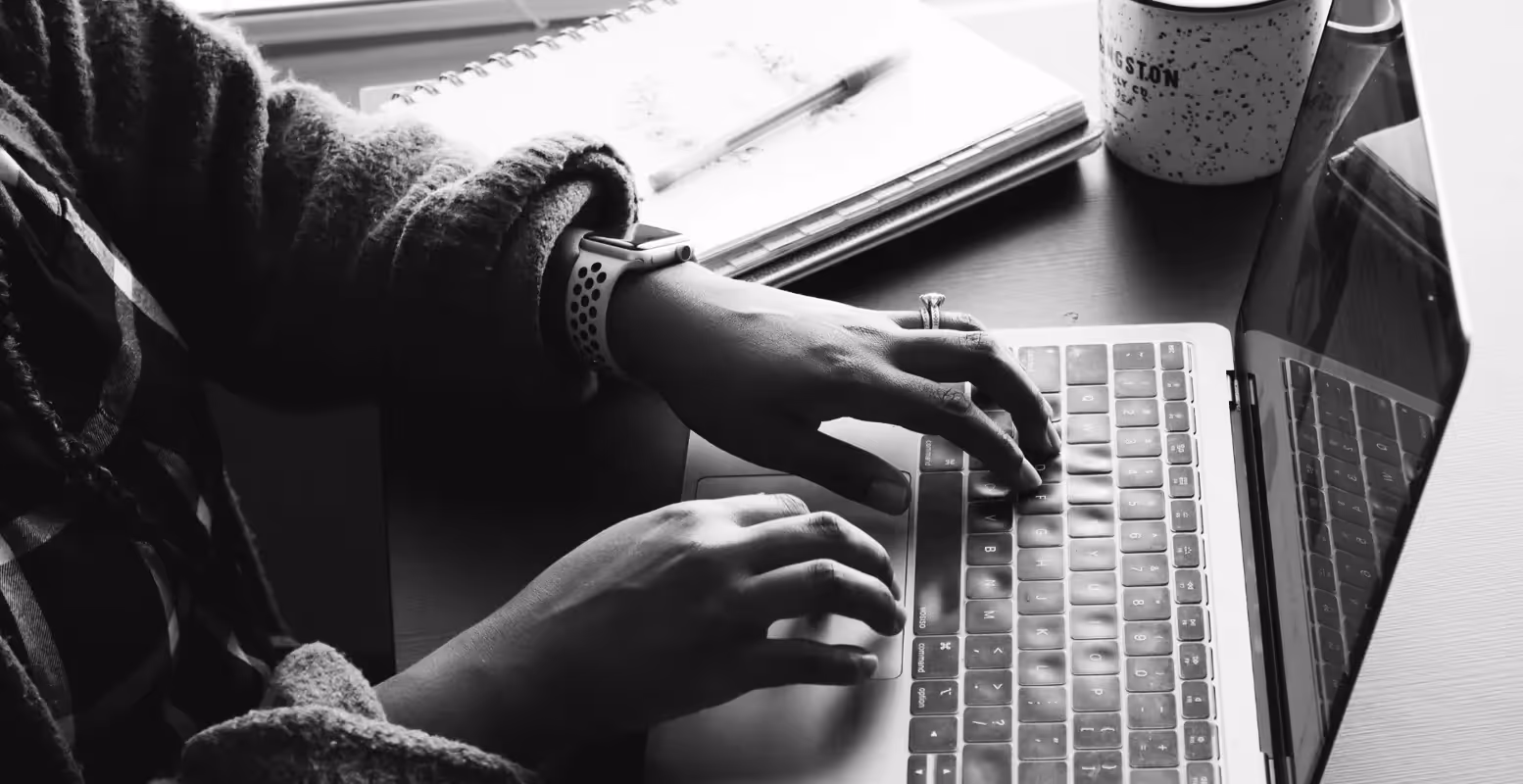 Hands of person working on laptop