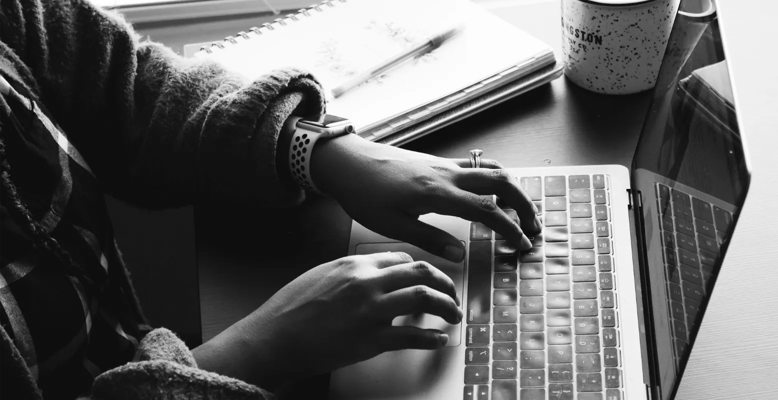 Hands of person working on laptop