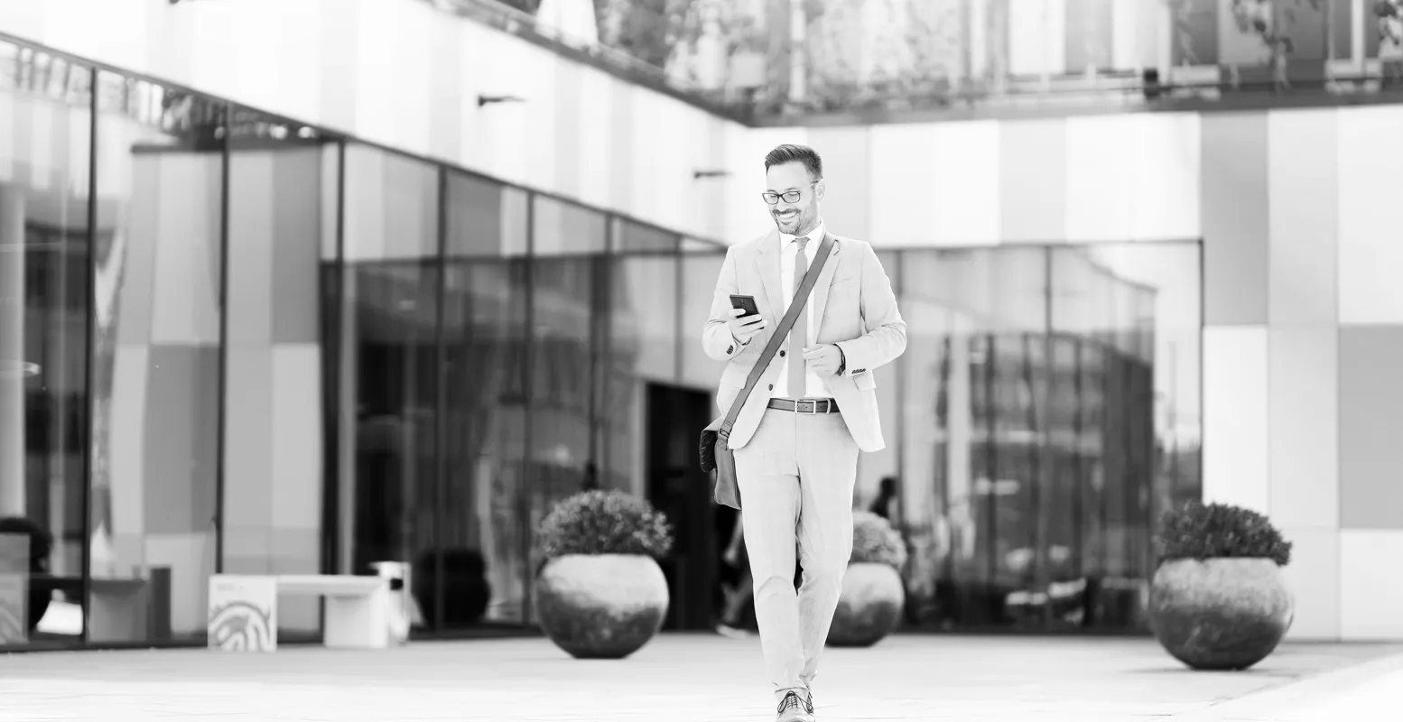 man walking looking at cell phone