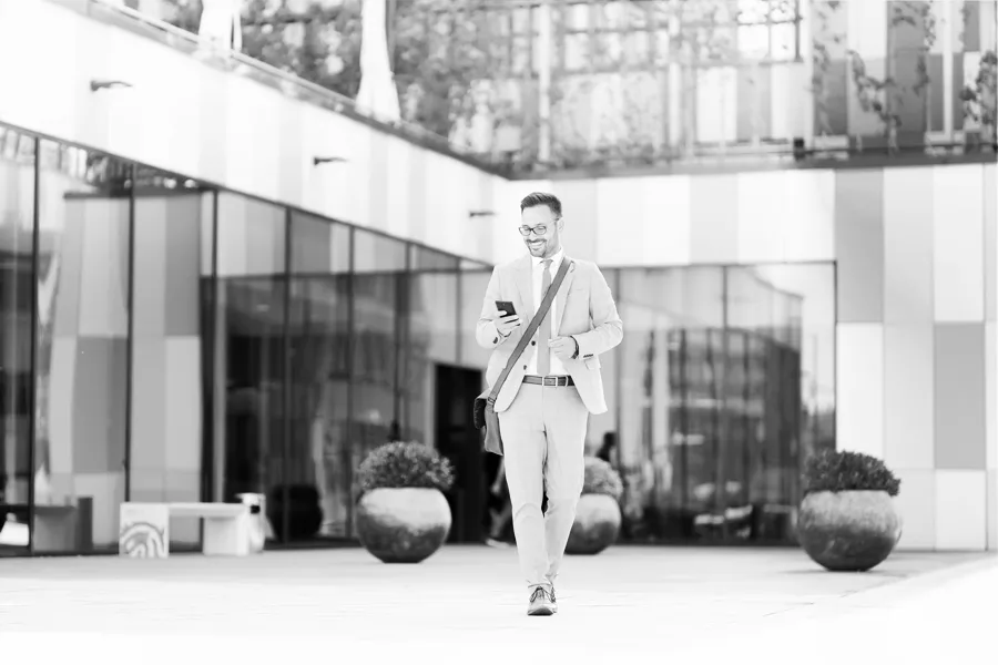 man walking looking at cell phone