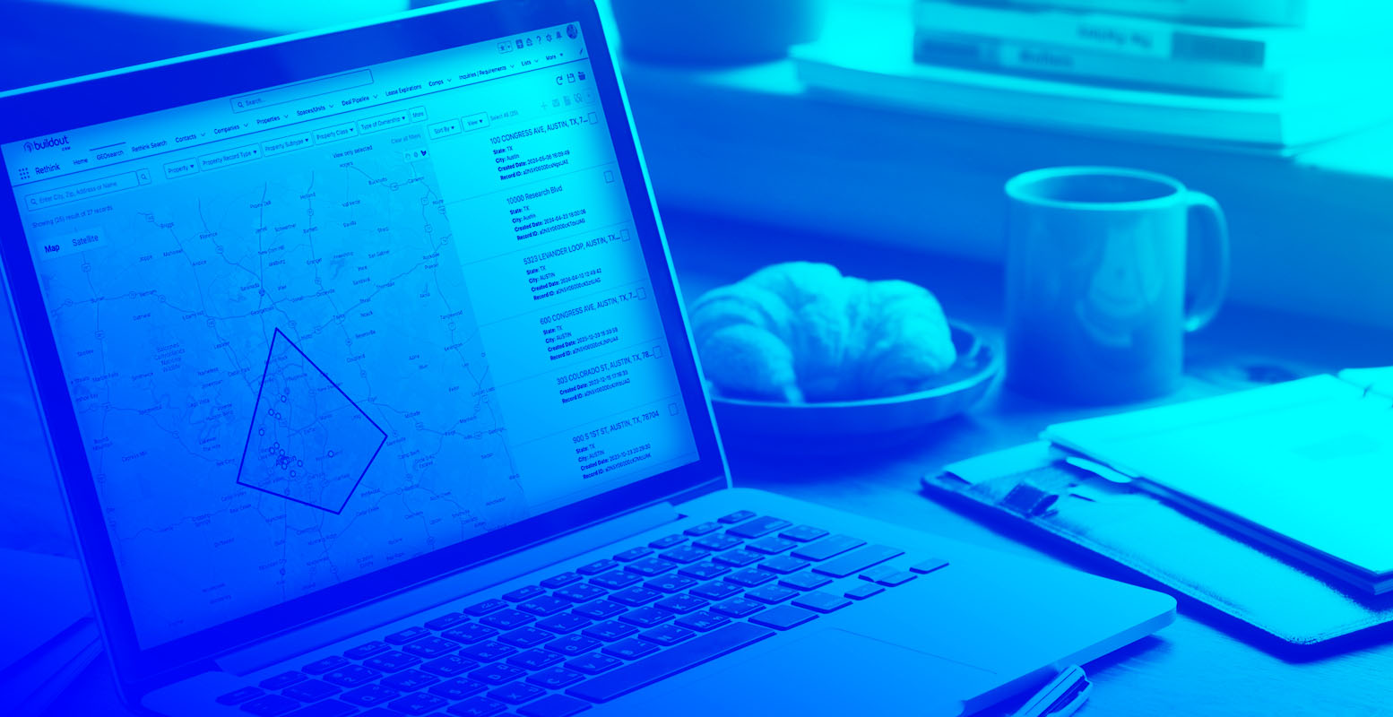Mock-up of Rethink by Buildout on a computer with a gradient overlay