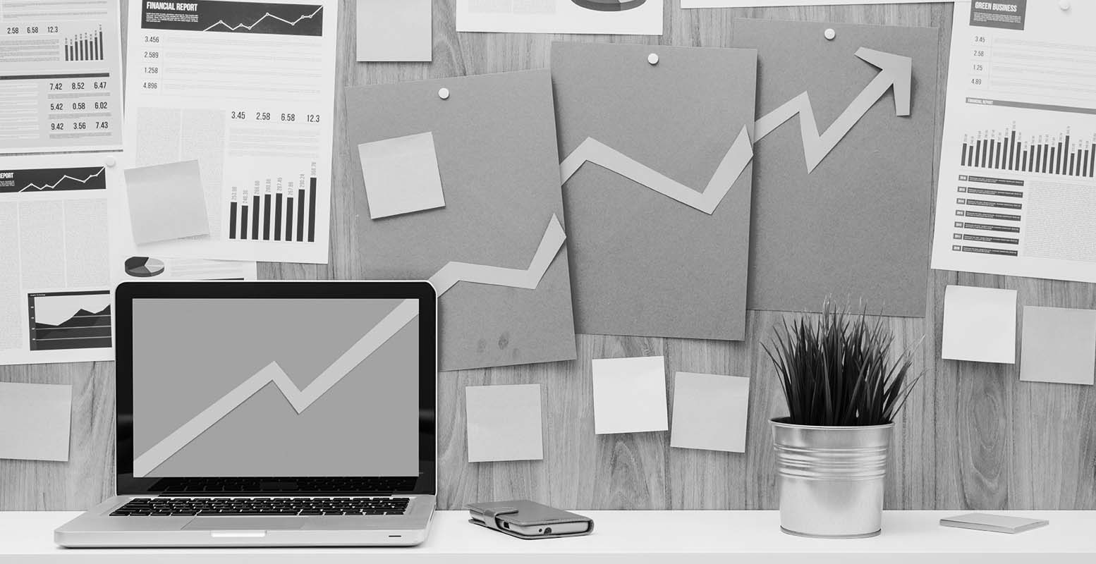 Craft paper graph extending up and over breaking out of a computer and onto wall