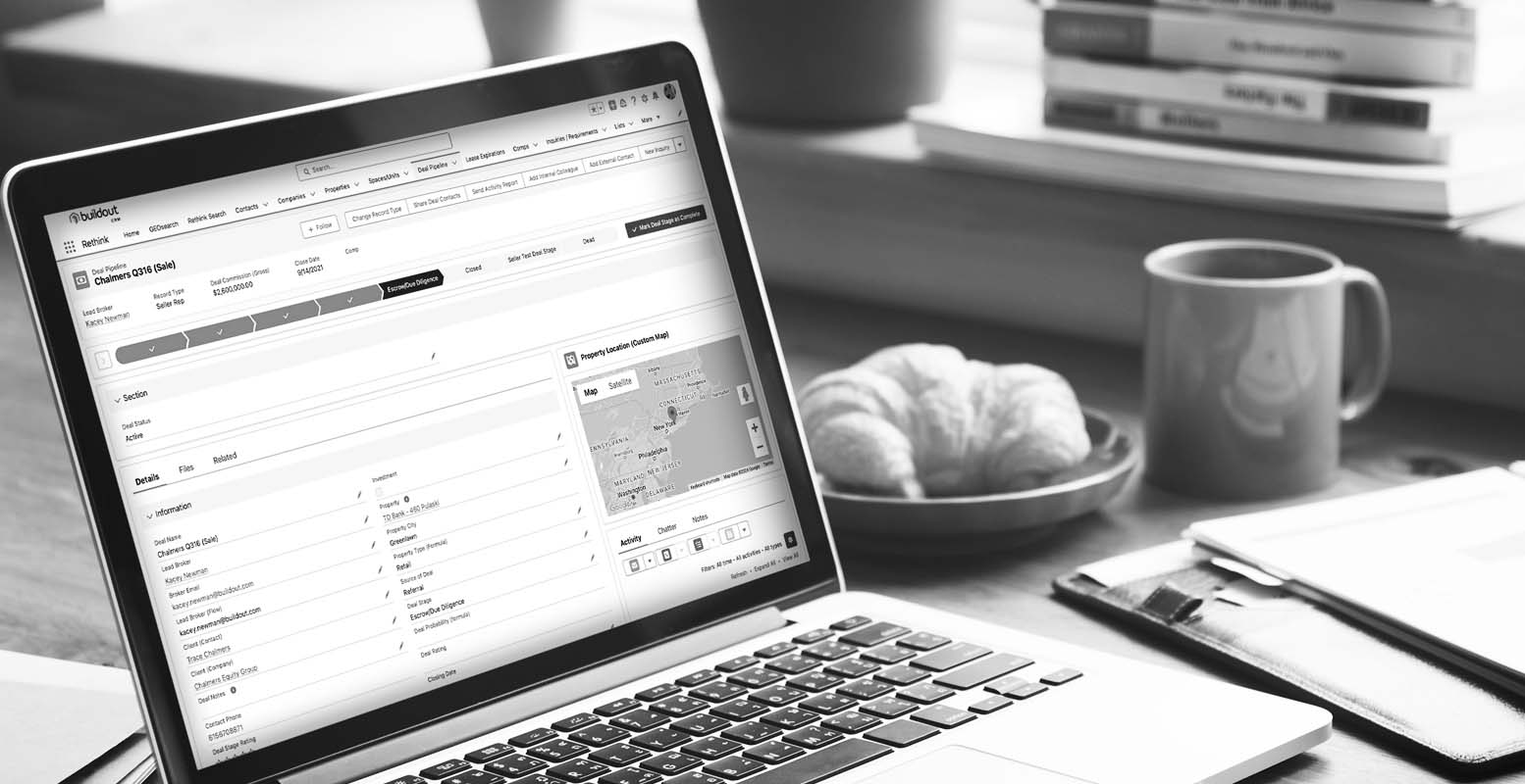 Mock-up of Rethink on computer sitting on a desk with coffee