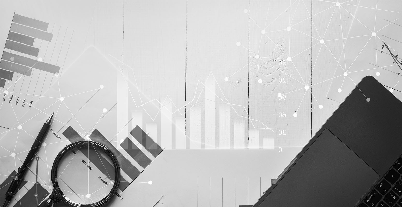 Overhead photo of graphs and numbers with a laptop