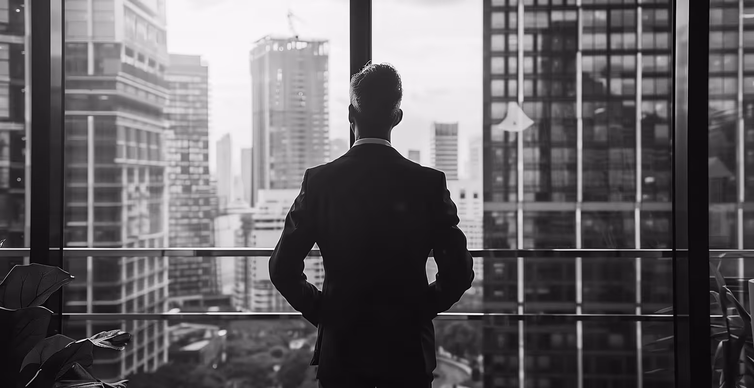 Aspirational business man looking out office window