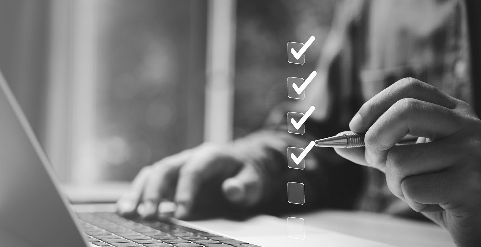 Man at computer with checklist overlay