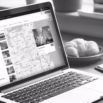 Laptop on a desk with a screenshot of Buildout CRM's property map