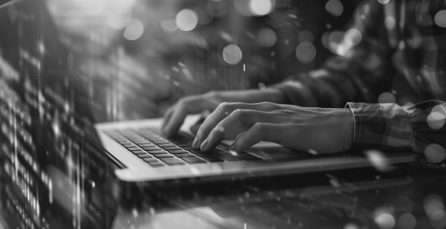 Person typing on computer with stylistic background