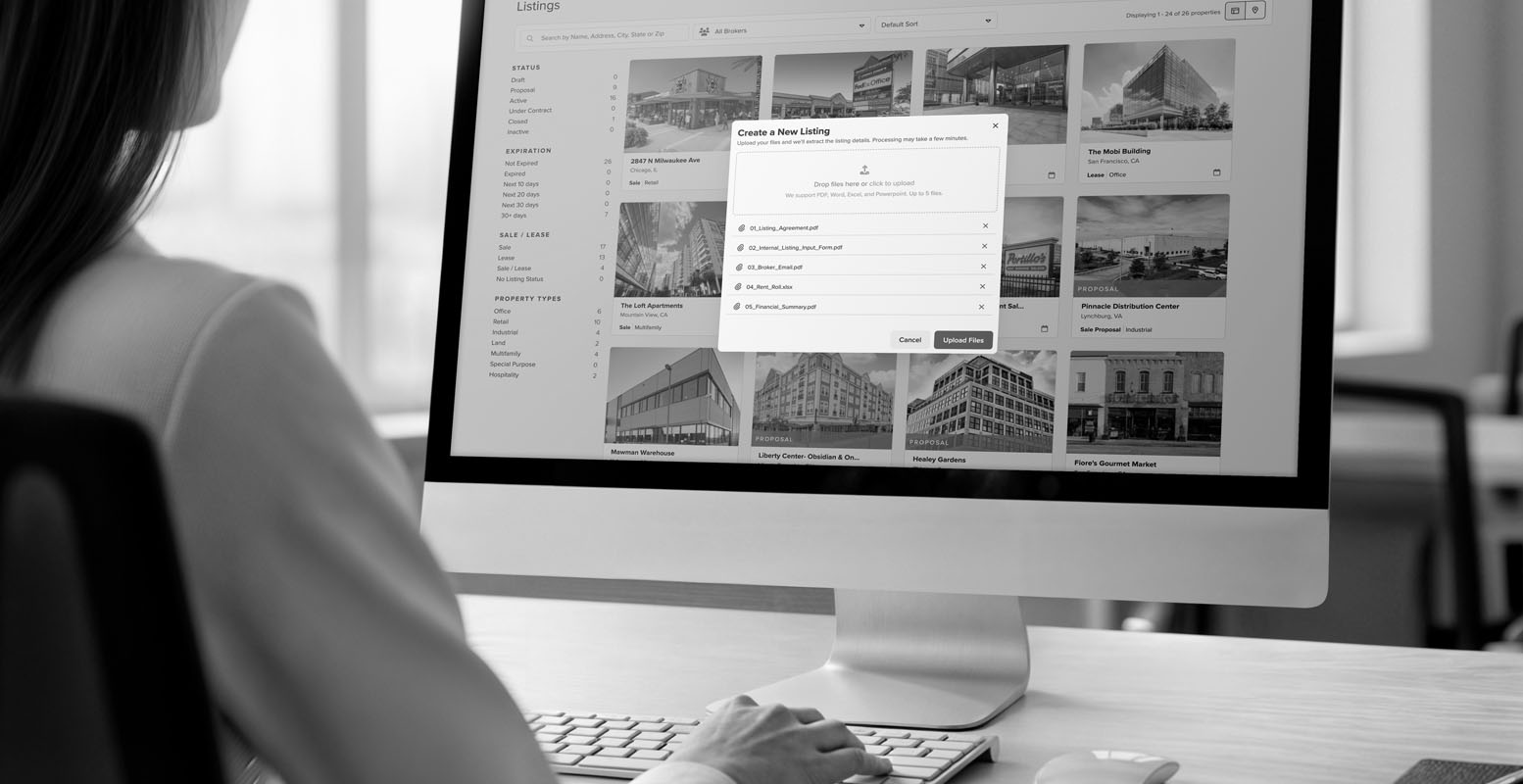 Woman sitting at a computer desk using Buildout's AI Data Ingestion feature