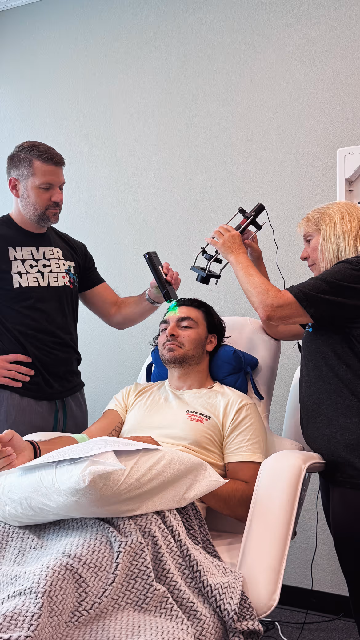 Someone laying in a patient bed receiving VSEL and EV treatment at NeuroSolution Center of Austin.