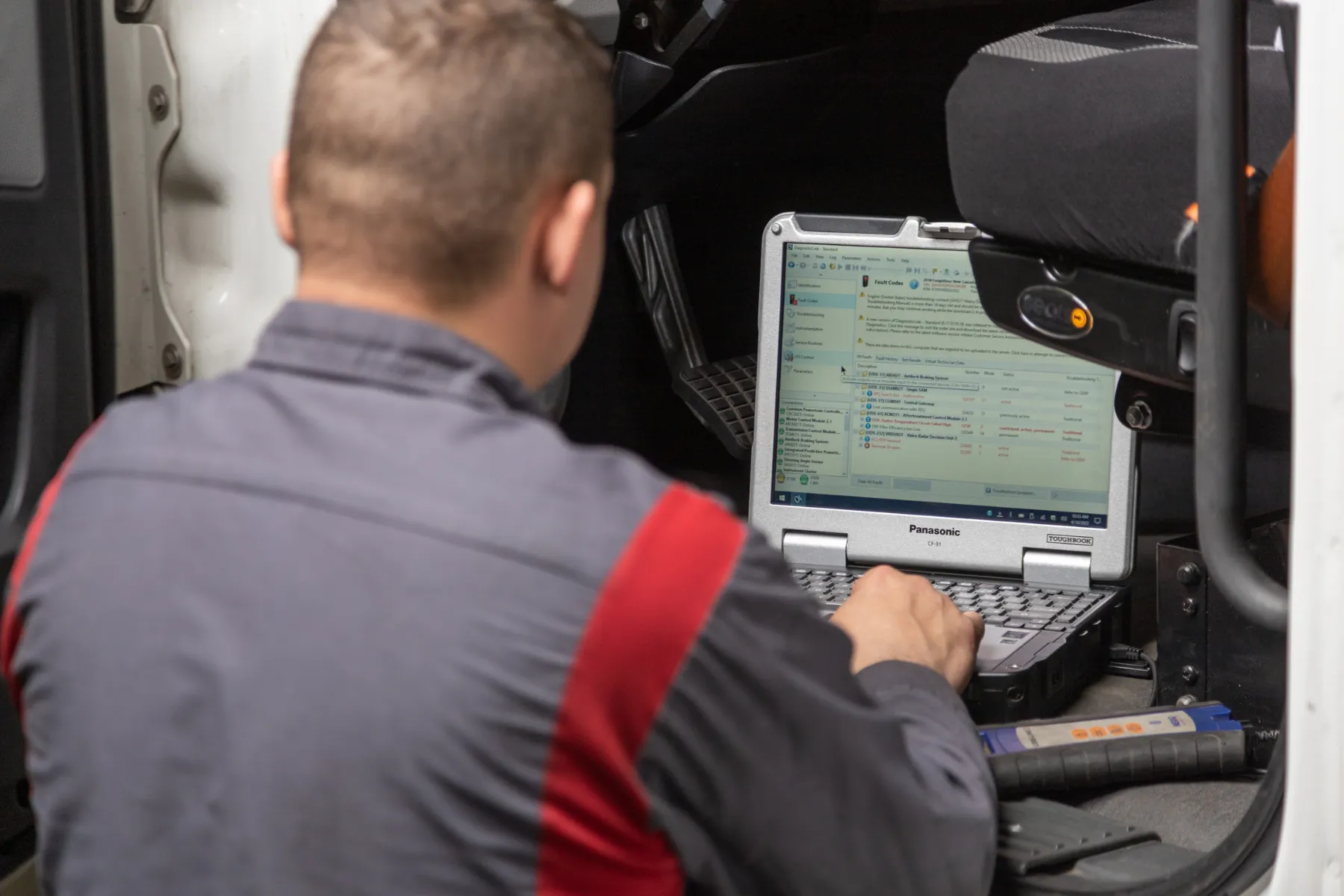 Diesel mechanic performing computer diagnostics on diesel truck in Chicago, Illinois