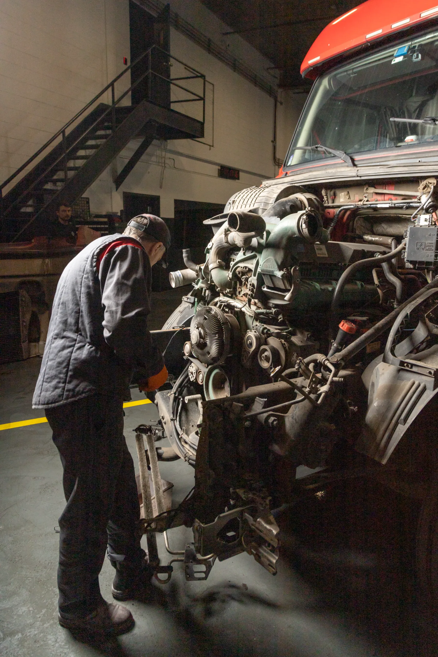 Diesel mechanic performing diesel engine repair services on semi truck in Chicago, Illinois