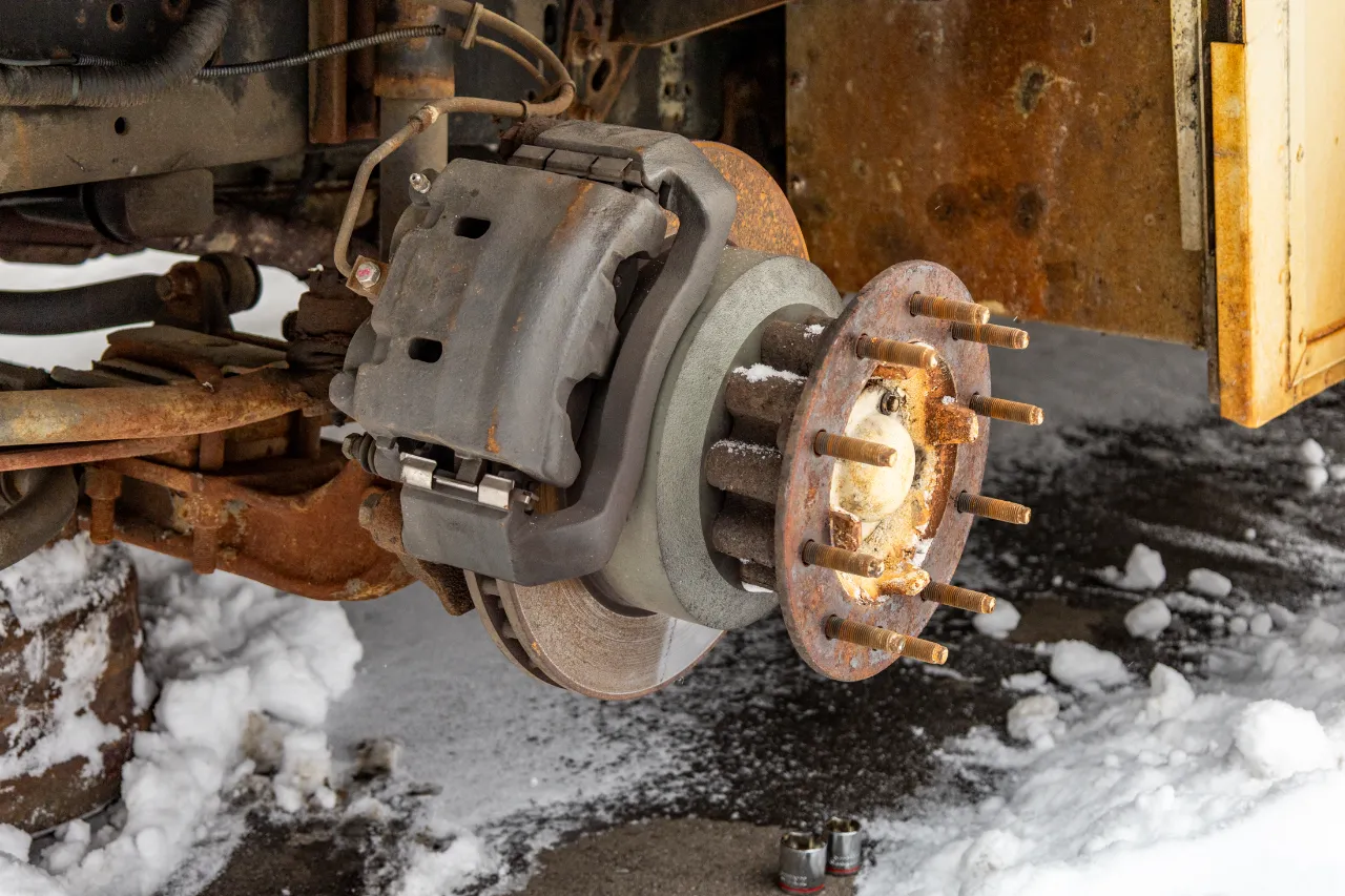 Heavy-duty truck brake rotor and wheel hub during commercial brake repair service.