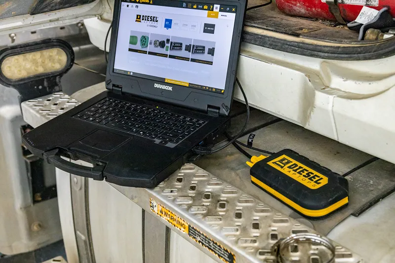 Diesel diagnostics setup with a Durabook laptop and Diesel Laptops adapter connected to a heavy-duty truck.