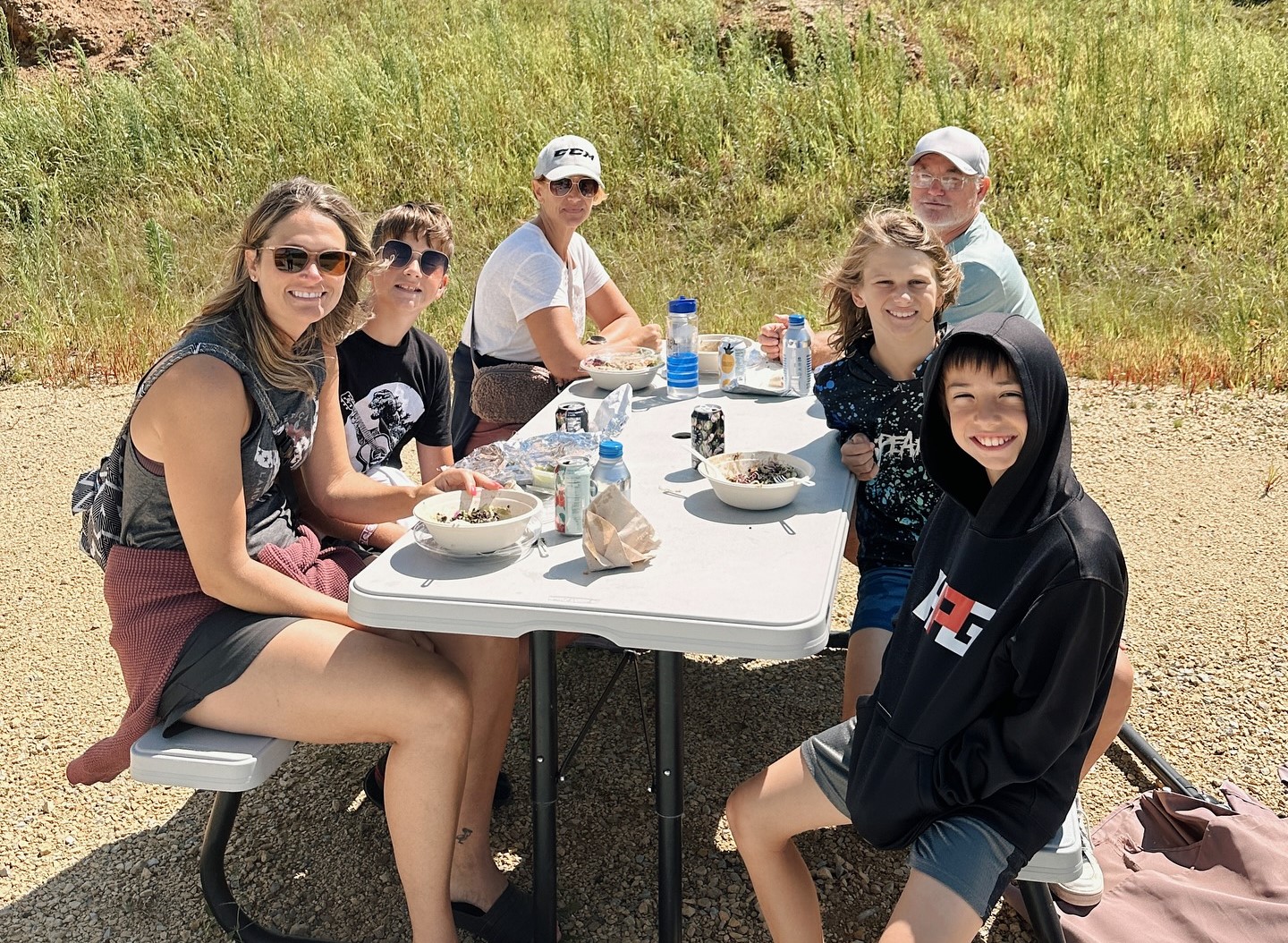 A group of six people having lunch from Forage Kitchen at the Flynn Creek Farm.