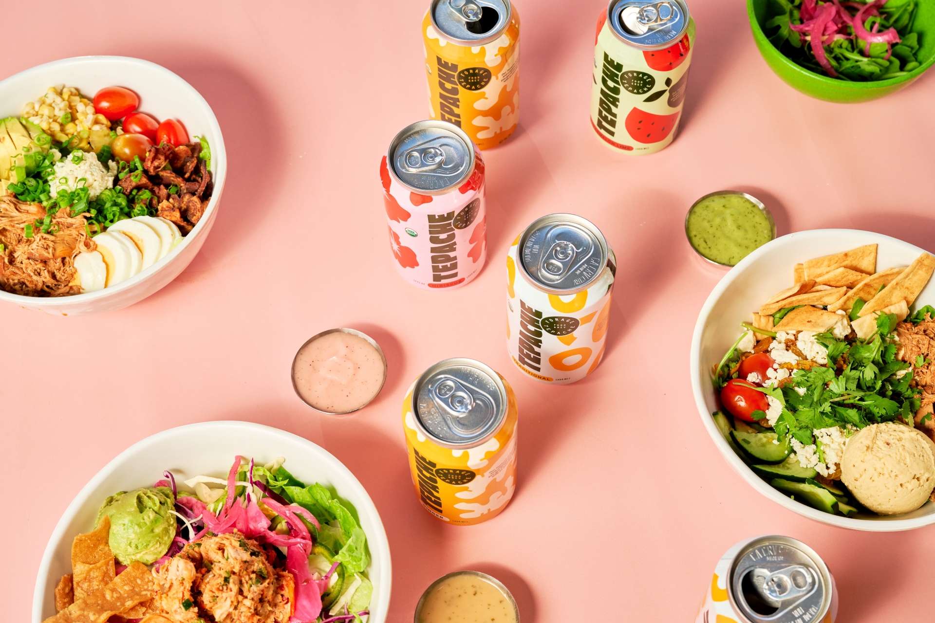  Forage Kitchen salad bowls and Tepache cans on the table.