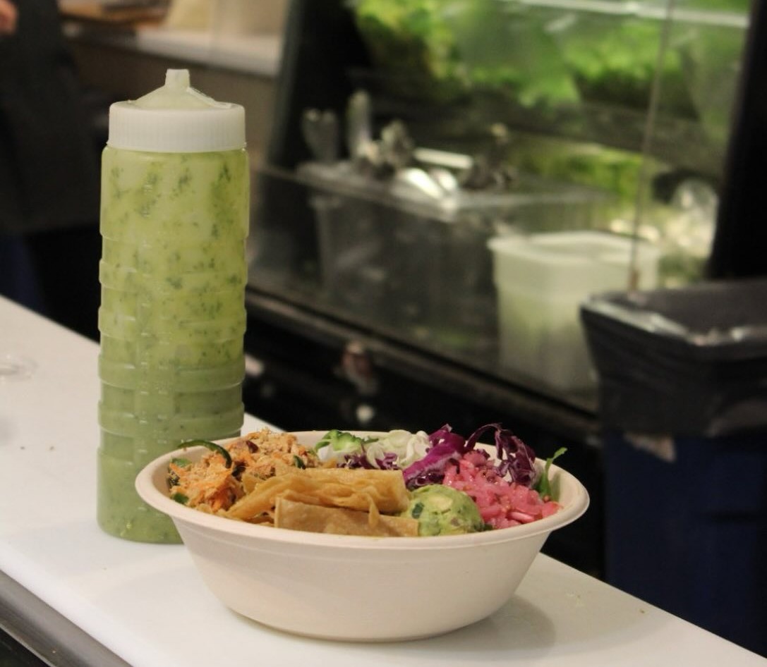  A bottle of Green Goddess Dressing and a salad bowl from Forage Kitchen.