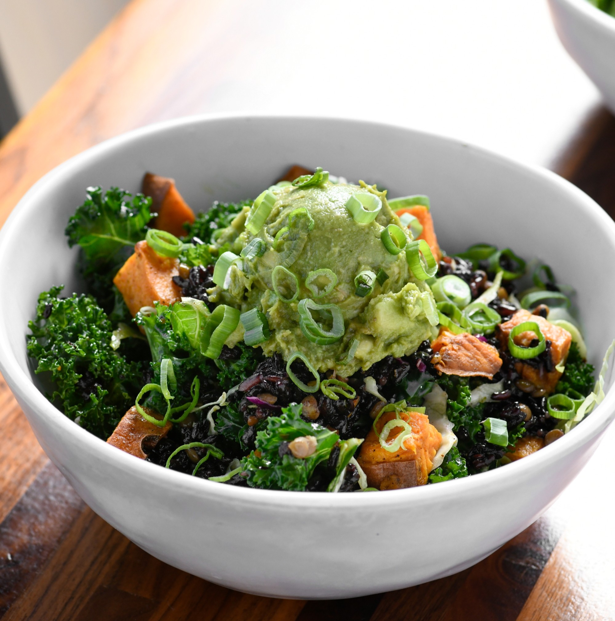  A Power Bowl with sweet potatoes and guacamole on a table at Forage Kitchen.