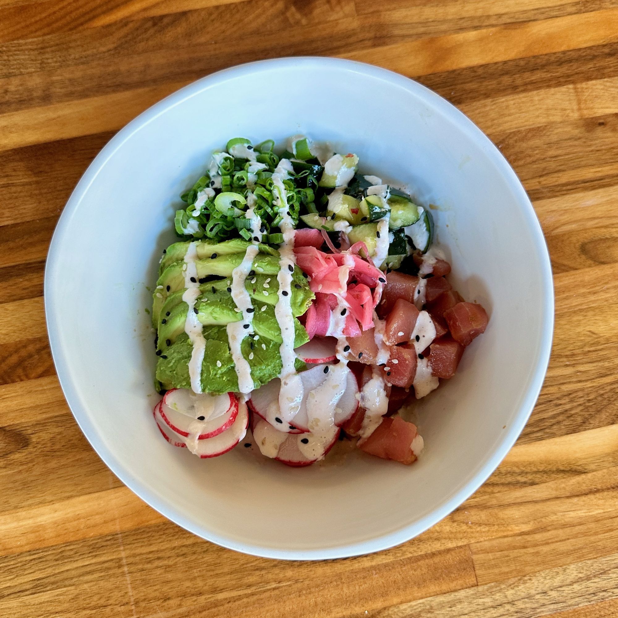 A close-up of a Tuna Poke Bowl with avocado, sashimi tuna, and more from Forage Kitchen.