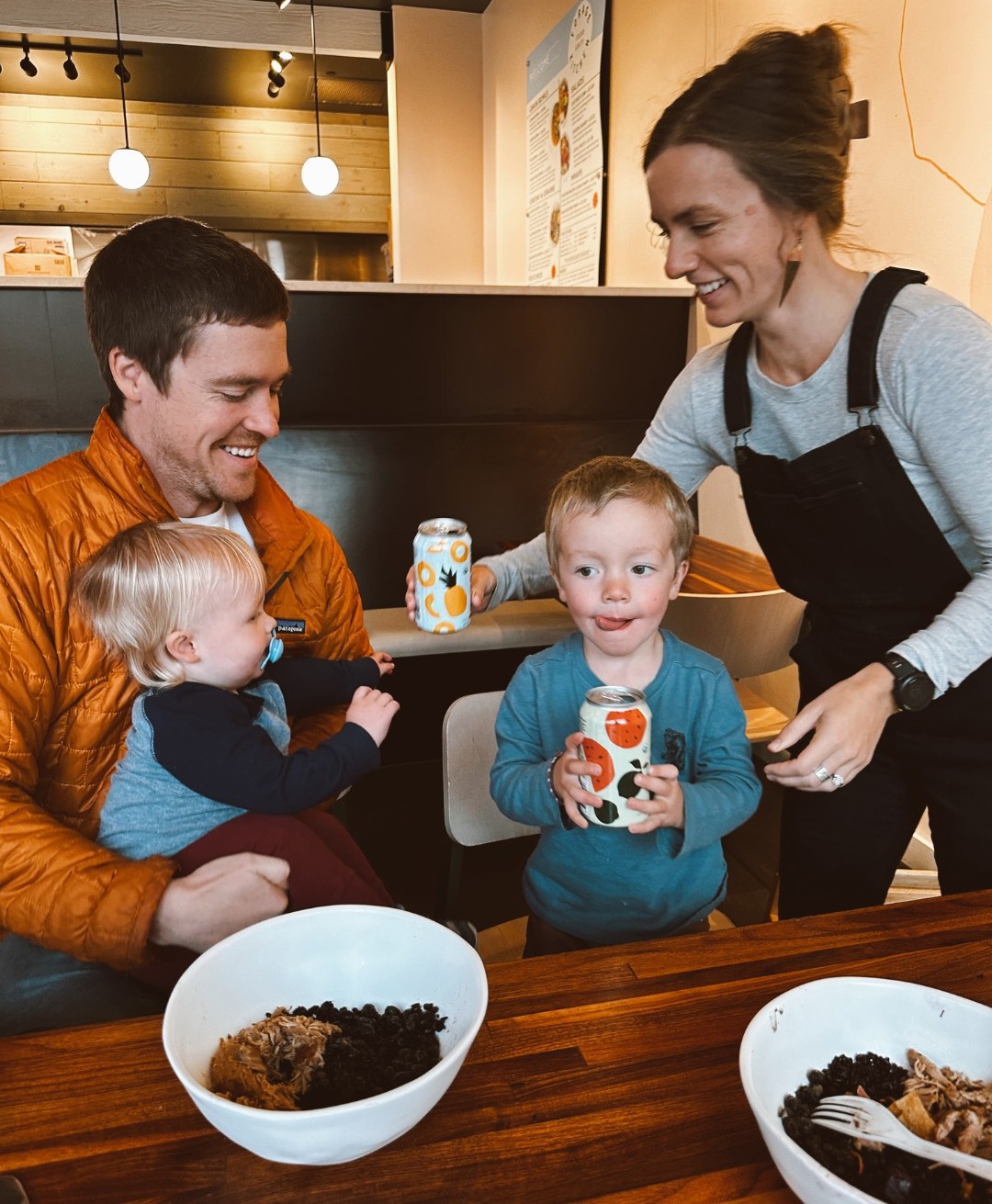 A family of four (a couple and two boys) enjoys grain bowls and beverages at Forage Kitchen.