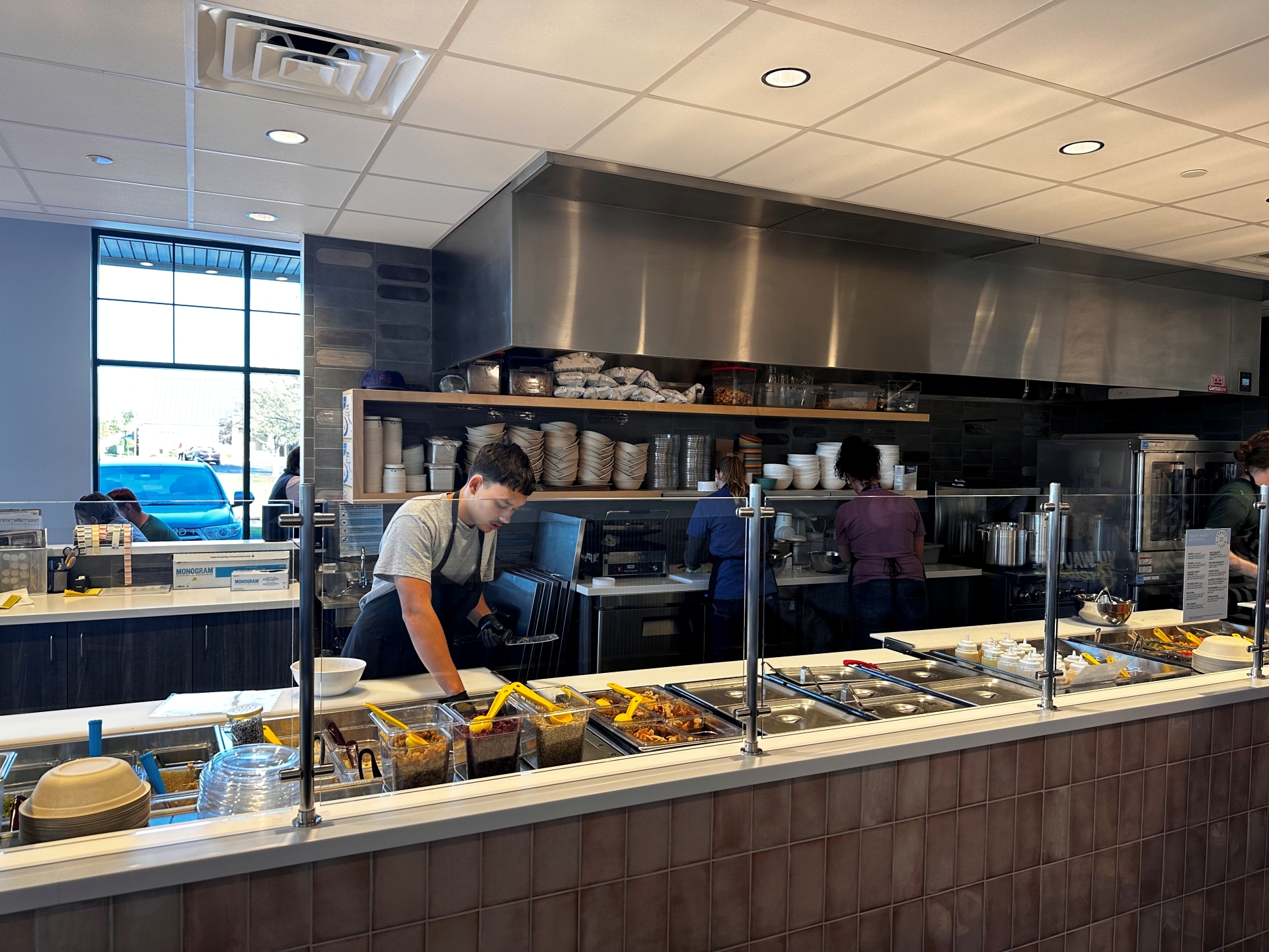  A salad builder at Forage Kitchen is making a bowl for a customer.