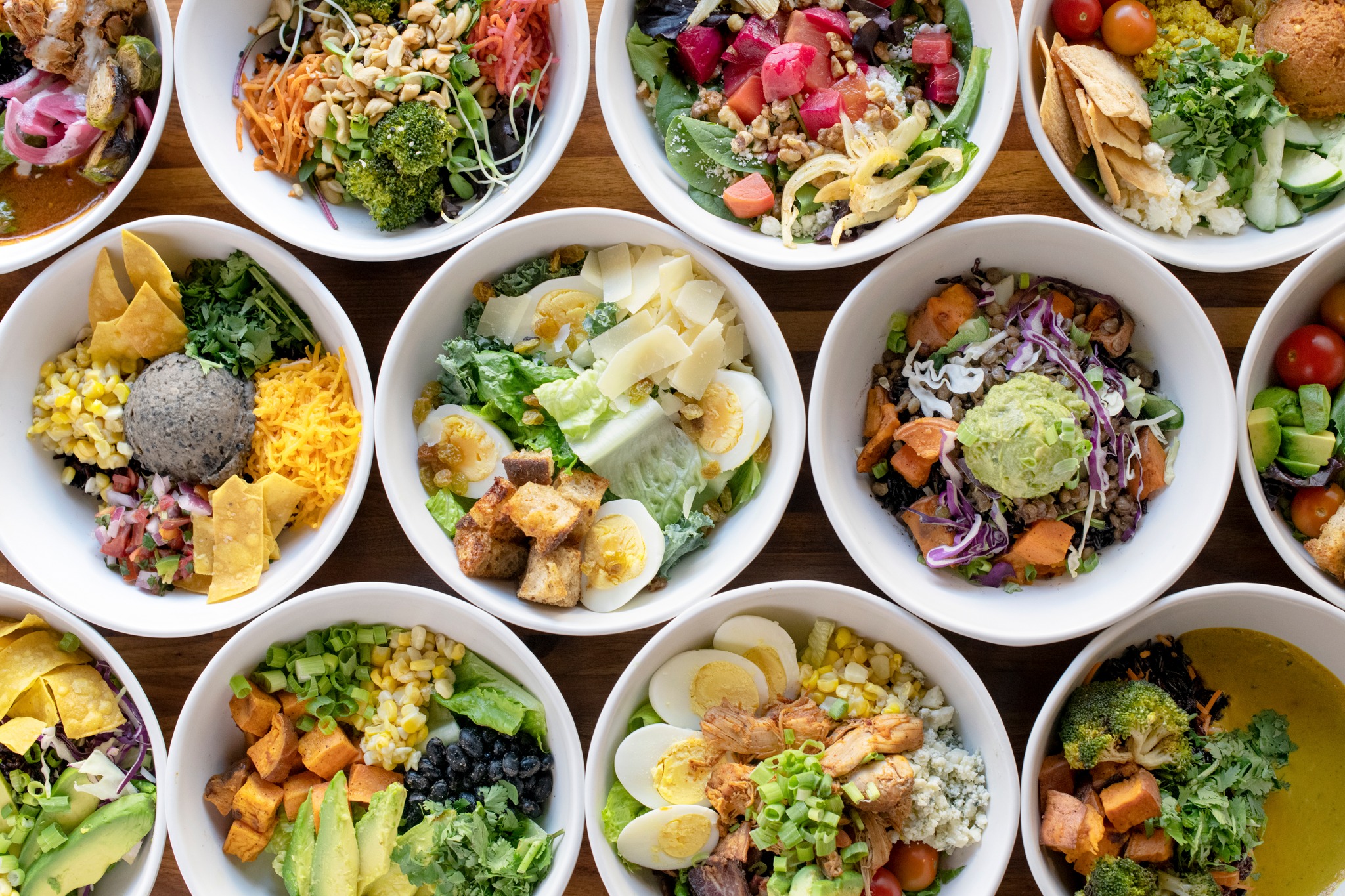 Vibrant and colorful grain bowls and salads on a table at Forage Kitchen restaurant in Whitefish Bay.