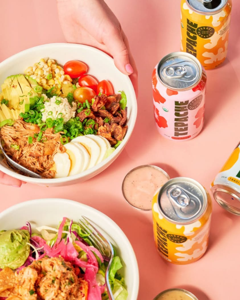 Two fresh grain and salad bowls with tepache drinks from Forage Kitchen catering.