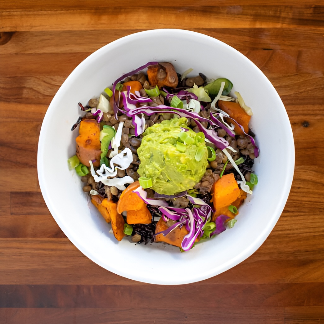 Forage Kitchen Power Bowl with black rice, sweet potatoes, poblano cabbage slaw, guacamole, green onion, avocado green goddess.